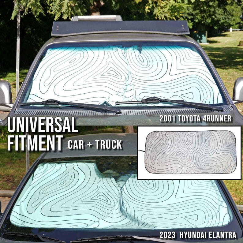 Pu&ograve; includere: Un parasole per parabrezza con sfondo bianco e linee di contorno topografiche nere. Il parasole &egrave; installato su una Toyota 4Runner del 2001 e una Hyundai Elantra del 2023, con il testo Universal Fitment Car + Truck.