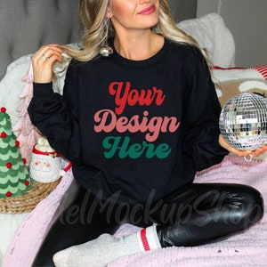 May include: A black sweatshirt with long sleeves and a crew neck. The sweatshirt has the text "Your Design Here" in a retro font with red, pink, and green colors.