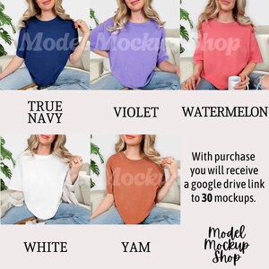 May include: A collection of short-sleeved t-shirts in various colors: true navy, violet, watermelon, white, and yam. Each shirt has a crew neck. The text "Model Mockshop" is visible on the shirts. The text "Model Mockup Shop" is also visible.