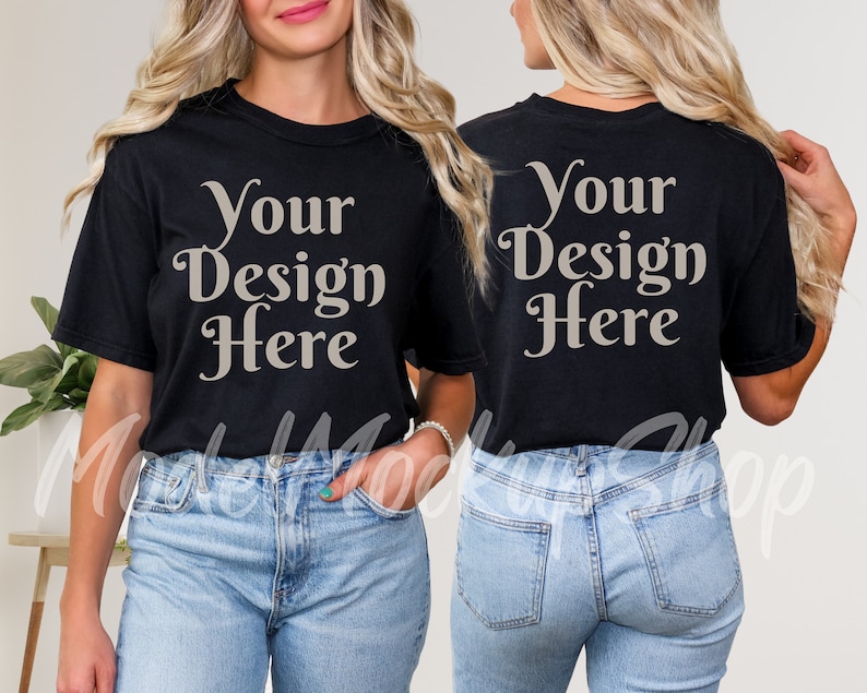May include: A black t-shirt with short sleeves and the text "Your Design Here" printed on the front and back in a light beige color. The model is wearing blue jeans.