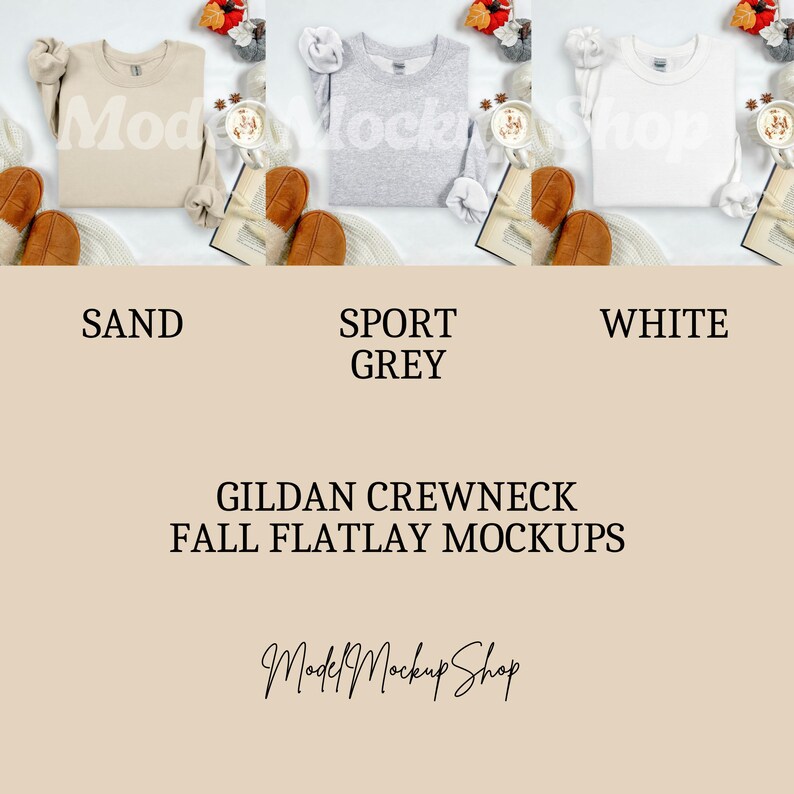May include: Three Gildan crewneck sweatshirts in sand, sport grey, and white are displayed in a flatlay mockup. The sweatshirts are surrounded by fall-themed decor, including a book, a coffee cup, and autumn leaves. The text "GILDAN CREWNECK FALL FLATLAY MOCKUPS" is visible.