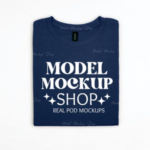 May include: A navy blue t-shirt with the text "MODEL MOCKUP SHOP" and "REAL POD MOCKUPS" in white.