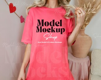May include: A pink oversized t-shirt with the text "Model Mockup Shop" and the tagline "Real Model & Product Mockups".
