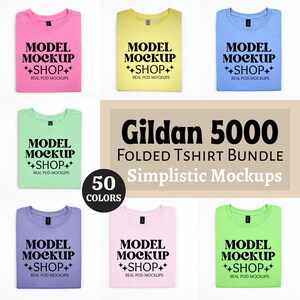 May include: A set of six folded Gildan 5000 t-shirts in various colours, including pink, yellow, blue, green, purple, and light pink. Each shirt has the text "MODEL MOCKUP ++SHOP++ REAL POD MOCKUPS" printed on the front. The text "Gildan 5000 FOLDED TSHIRT BUNDLE 50 COLORS Simplistic Mockups" is printed on a beige background.