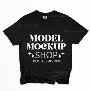 May include: Black t-shirt with the text "MODEL MOCKUP SHOP" in white, with star graphics. The words "REAL POD MOCKUPS" are below the shop name. The shirt has a crew neck and short sleeves.