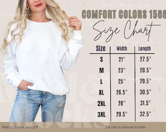 May include: A white sweatshirt with the text "COMFORT COLORS 1566" and a size chart. The size chart shows measurements in inches for sizes S to 3XL. The model is wearing a size M. The sweatshirt is a casual clothing item.
