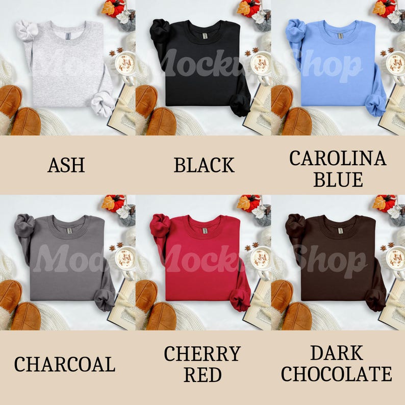 May include: A collection of six crewneck sweatshirts in various colors: ash, black, Carolina blue, charcoal, cherry red, and dark chocolate. Each sweatshirt is displayed with a cozy fall theme.