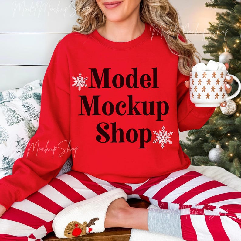 May include: A red sweatshirt with the text "Model Mockup Shop" and snowflake designs. The model is wearing red and white striped pants and white fuzzy slippers.