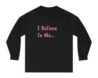May include: Black long-sleeve shirt with the text "I Believe In Me..." in pink, centered on the chest. The shirt has a crew neck and long sleeves. The fabric appears to be a soft, comfortable material.