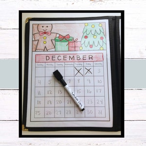 May include: A white dry-erase calendar with a December theme. The calendar has a gingerbread man, a Christmas tree, and presents drawn on it. The days of the week are labeled, and the numbers 1 through 31 are written in the boxes. The days 8 and 9 are crossed out with an X.