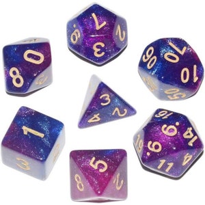 May include: Set of seven polyhedral dice with a galaxy-themed design. The dice are purple and blue with gold glitter and gold numbers. The dice are a d4, d6, d8, d10, d%, d12, and d20.