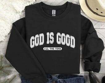 May include: Black sweatshirt with white text that reads "God is Good" with the words "All the Time" underneath.