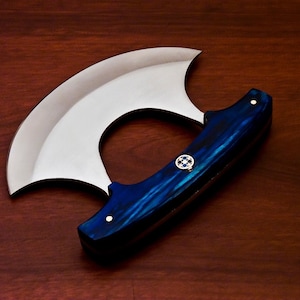 May include: A blue and silver chef's knife with a curved blade and a handle made of blue wood.