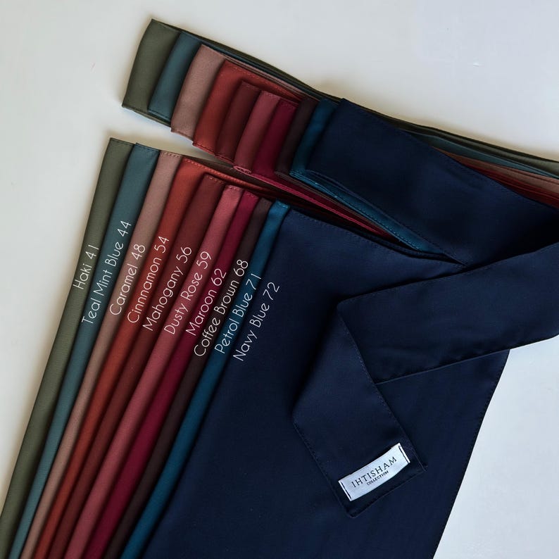 May include: A collection of 10 different colored fabric swatches, arranged in a row from lightest to darkest. The swatches are labeled with their color names and corresponding numbers. The colors are: Haki 41, Teal Mint Blue 44, Caramel 48, Cinnamon 54, Mahogany 56, Dusty Rose 59, Maroon 62, Coffee Brown 68, Petrol Blue 71, and Navy Blue 72.
