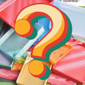 May include: A collection of colorful plastic trays, in shades of red, blue, orange, and yellow, are arranged together. The trays have a ridged interior. A large, stylized question mark in rainbow colors overlays the trays, suggesting a craft or DIY project.