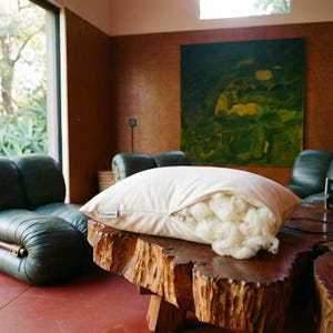 May include: A set of three ceramic mugs with a speckled, matte finish. Each mug features a different color: light blue, cream, and gray. The mugs have a simple, modern design with a rounded shape and a handle.