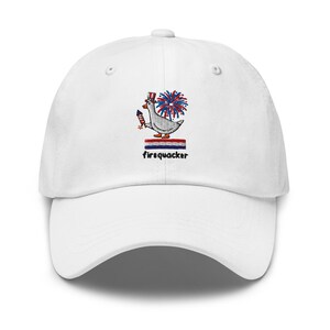 May include: A white baseball cap featuring an embroidered graphic of a goose wearing a red, white, and blue top hat, holding a firework, with a firework burst behind it, a red, white, and blue striped bar, and the text firequacker below.