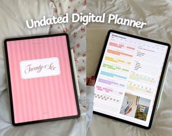 May include: Two tablets displaying a digital planner. One tablet shows a pink striped cover with the text "Twenty Six" in a white frame. The other tablet displays a colorful monthly dashboard. The text "Undated Digital Planner" is at the top.