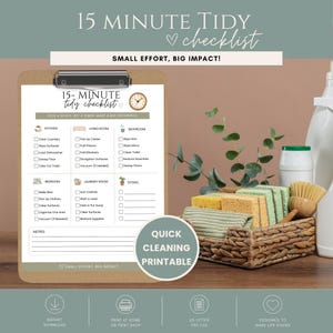 May include: A clipboard holding a 15-minute tidy checklist with sections for kitchen, living room, bathroom, bedroom, laundry room, and extras. The checklist features icons, checkboxes, and the text 15-MINUTE TIDY CHECKLIST. A woven basket with sponges and a brush sits nearby.