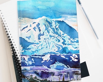May include: Watercolor painting of a snow-capped mountain with a blue sky and clouds. The mountain is painted in shades of blue and white, with hints of purple in the foreground.