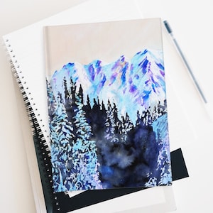 May include: Watercolor painting of a snowy mountain range with a forest in the foreground. The mountains are painted in shades of blue, purple, and white, while the forest is painted in shades of black and blue.