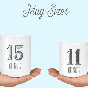 May include: Two white ceramic mugs with black text. The larger mug is 15 ounce and the smaller mug is 11 ounce.