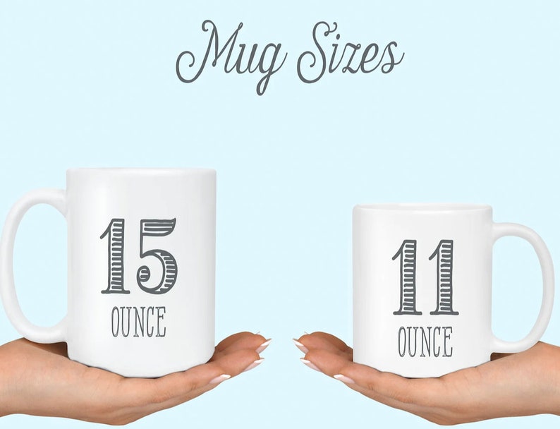 May include: Two white ceramic mugs with black text. The larger mug is 15 ounce and the smaller mug is 11 ounce.