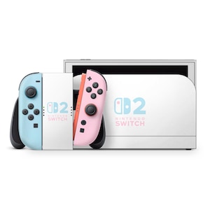 Peut inclure: Une console Nintendo Switch blanche avec deux manettes détachables. Une manette est bleu clair, l'autre est rose. La console et les manettes portent l'inscription "Nintendo Switch".