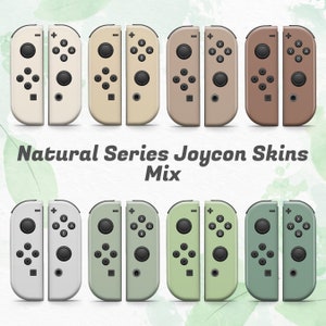 Peut inclure: Huit skins de manettes Joy-Con de couleurs différentes. Les skins sont disposées en deux rangées de quatre. La rangée du haut présente des skins beige, brun clair, brun et brun foncé. La rangée du bas présente des skins blanches, vert clair, vert et vert foncé. Le texte "Natural Series Joycon Skins Mix" est situé sous les skins.