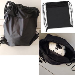 May include: Black drawstring bag with a zipped pocket and a mesh panel. The bag is shown empty and with a football inside. The bag has black drawstrings and a zip.