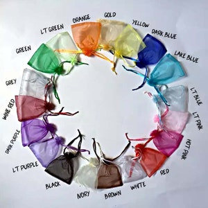 May include: A variety of colours of small, sheer drawstring bags arranged in a circle. The colours are: grey, wine red, dark purple, light purple, black, ivory, brown, white, red, hot pink, light pink, light blue, lake blue, dark blue, yellow, gold, orange, light green, and green.