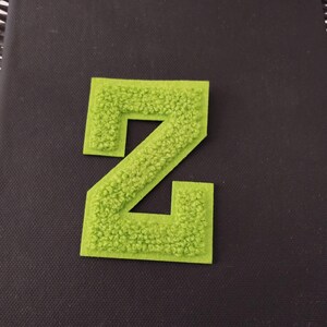 May include: A green felt letter Z, ideal for adding a personalised touch to crafts, clothing, or home decor.