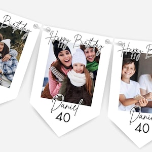 May include: White banner with family photos, text reads "Happy Birthday Daniel 40". The banner features multiple pennants with photos of a family, ideal for a birthday celebration. The banner is strung together with white string.
