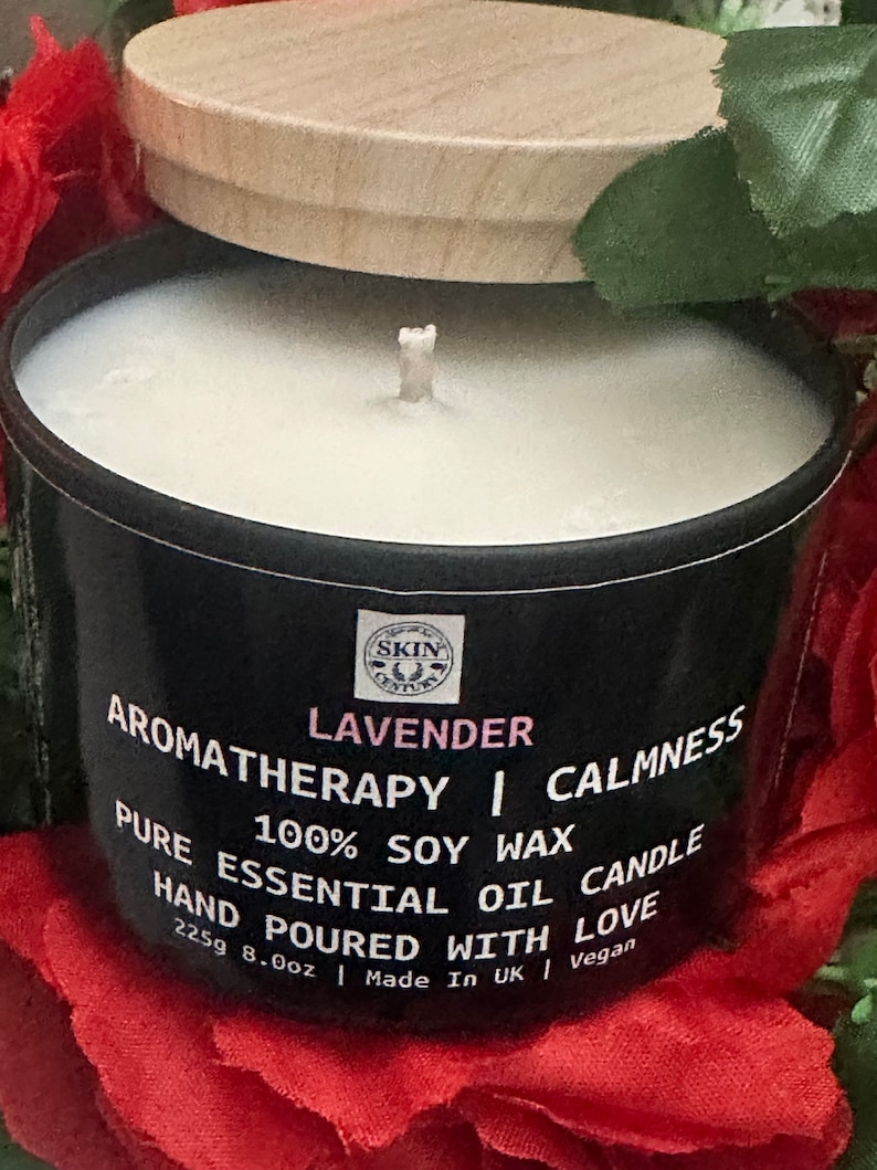 May include: A black candle jar with a wooden lid. The label reads "LAVENDER AROMATHERAPY | CALMNESS PURE 100% SOY WAX CANDLE ESSENTIAL OIL HAND POURED WITH LOVE 225g 8.0oz | Made In UK | Vegan".
