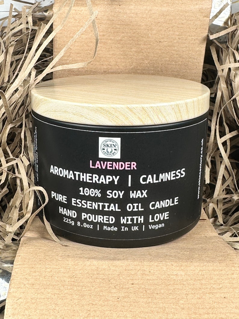 May include: A black candle jar with a wooden lid. The label reads "LAVENDER AROMATHERAPY | CALMNESS 100% SOY WAX PURE ESSENTIAL OIL CANDLE HAND POURED WITH LOVE 225g 8.0oz | Made In UK | Vegan".