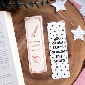 May include: Two bookmark designs. The first bookmark is white with a brown border and features a quill pen and inkwell with the text "Long story short I survived." The second bookmark is white with black stars and the text "You drew stars around my scars."