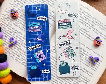 May include: Two colorful bookmarks with a witch and book theme. The blue bookmark features a witch's hat, a cauldron, and a book with a crescent moon. The white bookmark features a witch's hat, a cauldron, and a book with a crescent moon. Both bookmarks have the words "witchy" and "readers" on them.