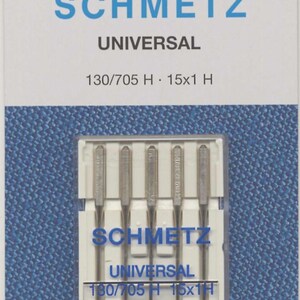 May include: Package of SCHMETZ Universal sewing machine needles. The package is white with blue text and a blue background. The needles are in a clear plastic case. The text on the package includes "SCHMETZ", "UNIVERSAL", and "130/705 H 15x1 H".