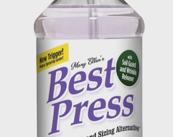May include: A clear plastic spray bottle of Mary Ellen's Best Press, a clear starch and sizing alternative. The bottle has a white label with purple text and a lavender scent. It features a new trigger and soil guard.
