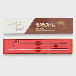 May include: A Birds Nest Untangling Toolkit, presented in a two-piece box. The top box is white and brown with the text "Madam Sew" and "BIRDS NEST UNTANGLING TOOLKIT". The bottom box is red and contains three metal tools.