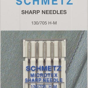 May include: Package of SCHMETZ sewing machine needles. The package is white with blue text that reads "SCHMETZ SHARP NEEDLES 130/705 H-M". The needles are labeled "MICROTEX SHARP NEEDLE 80/12".