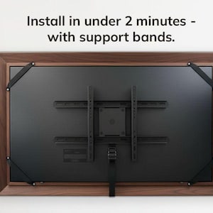 a television mounted on a wall, with instructions on how to install it.
