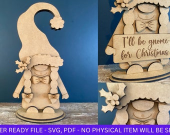 May include: A wooden gnome figurine with a red hat, white beard, and a sign that reads "I'll be gnome for Christmas".