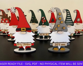 May include: Set of nine wooden Christmas gnomes with different colored hats and personalized signs. The signs include the names "Adam", "Believe", "Ho Ho Ho", "Merry Christmas", "Let it Snow", and "Say".