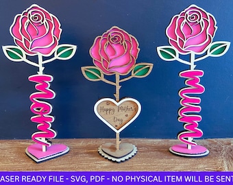 May include: Three laser cut wooden rose designs. Two of the roses have the word "mom" spelled out on the stem. The third rose has a heart-shaped sign that says "Happy Mother's Day".