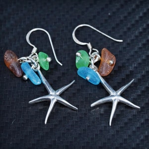 May include: Silver starfish earrings with dangling sea glass charms in shades of blue, green, and brown.