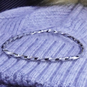 Size 8, vintage Monet silver tone twisted bangle, bracelet, stamped Monet