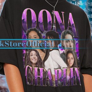 May include: Black unisex t-shirt featuring the text "OONA CHAPLIN" in purple, with images of women. The shirt is oversized and has short sleeves. The text "SickStoreOfficial" is also visible.
