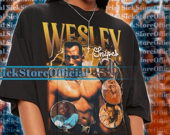 May include: A black t-shirt with a graphic print of Wesley Snipes from the movie "Passenger 57". The graphic features a portrait of Wesley Snipes with the text "Wesley Snipes" in yellow letters.