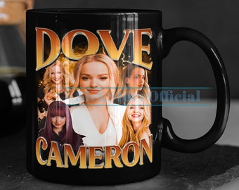May include: Black ceramic mug with a photo collage of Dove Cameron. The mug has the text "Dove Cameron" in gold lettering.